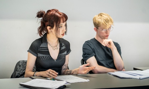 Two students discussing their work.