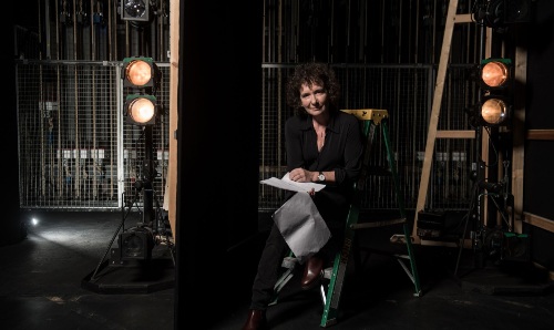 Jeanette Winterson sitting with a script backstage.