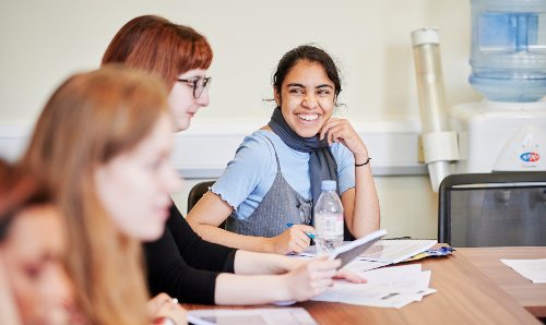 A student smiling in class