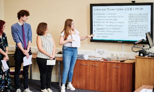 Four students standing doing a presentation