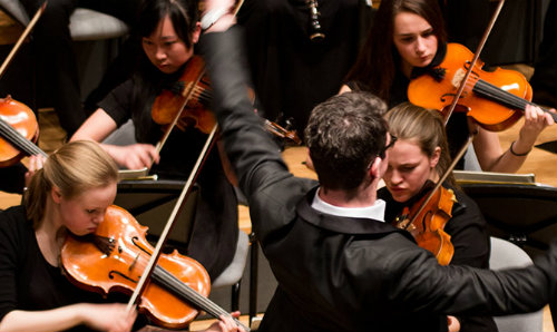 conductor and string orchestra